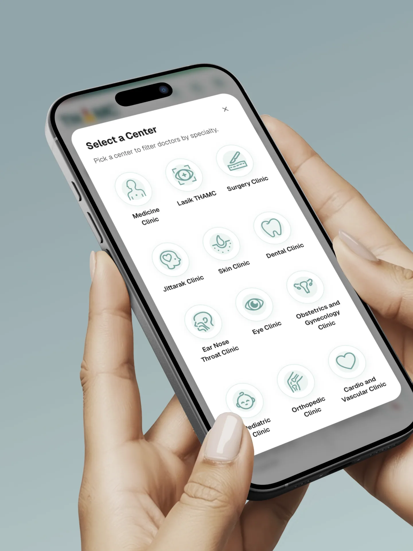 Hands holding a phone showing the THAMC clinic directory, with an icon for each specialty centre